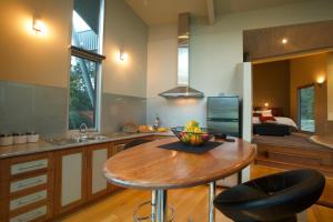 a kitchen with a table with a bowl of fruit on it at Bushland in Halls Gap