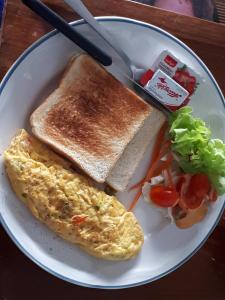 a plate of breakfast food with eggs and toast at We Love Kata in Kata Beach