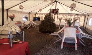 a tent with chairs and a christmas tree in it at Bhaga Eco Camp in Jispa