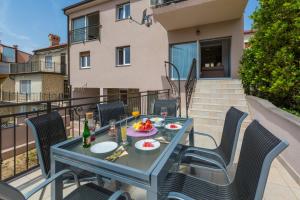 a table and chairs on the balcony of a apartment at Gold Sea in Crikvenica