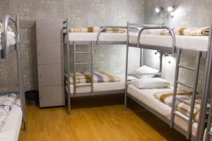 a room with three bunk beds in a room at Хостел и Апартаменты Друзья in Dnipro