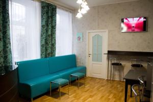 a living room with a blue couch and a bar at Хостел и Апартаменты Друзья in Dnipro