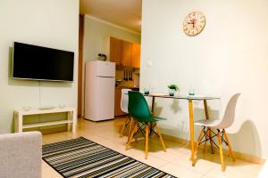 a living room with a table and a refrigerator at Aegean Studio by the Sea in Perea