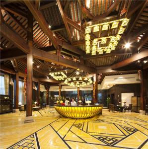 a lobby with a large yellow fountain in the middle of a building at Dockside Boutique Hotel (In Xizha Scenic Area - ticket included) in Tongxiang