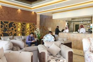 a lobby of a hotel with couches and a bar at Seasons Apartments in Jazan