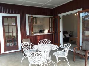a white table and chairs on a patio at Woodside Orchard in Greytown