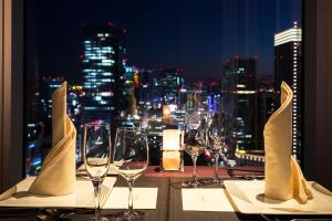 
a view from a balcony overlooking a city at night at Hotel Metropolitan Tokyo Marunouchi in Tokyo
