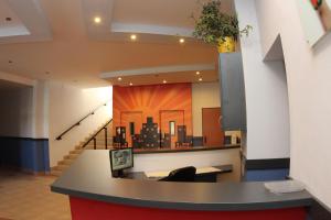 an office lobby with a mural of a city at City Building in Šaca