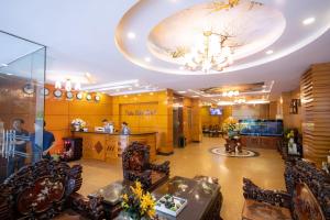 a lobby with chairs and a table and a chandelier at Bon Ami Hotel - Thiên Xuân Hotel in Ho Chi Minh City