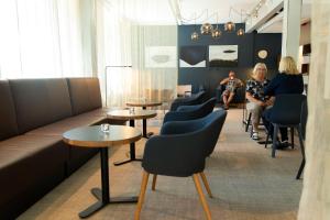 a group of people sitting in a waiting room at Park Alandia Hotel in Mariehamn