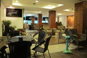 a lobby with chairs and a table and a restaurant at Jomtien Hostel 3 in Jomtien Beach +9 photos