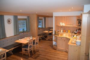 a restaurant with tables and chairs in a room at Haus Gstrein in Obergurgl