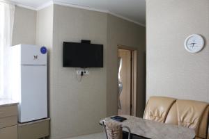 ゲレンジークにあるКвартира для отдыхаの壁にテレビとテーブルが備わる客室です。