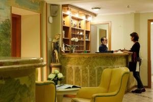 two women standing at a counter in a salon at Residence Liberty in Trieste