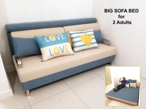 a couch with pillows that say big soa bed for adults at HomezStay Soho Timesquare Miri in Miri