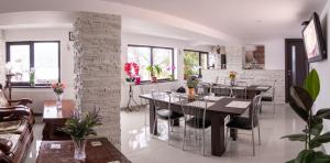 a kitchen and dining room with a table and chairs at Casa Lazar in Buşteni