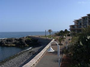 a bridge over a body of water next to a building at Apartamento Reis Magos in Caniço +12 photos