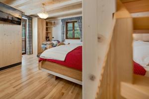 una camera con un letto con una coperta rossa di Millenniumhotel a Vigo di Fassa