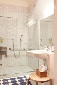 a bathroom with a shower, sink, and tub at 60 Balconies Design in Madrid
