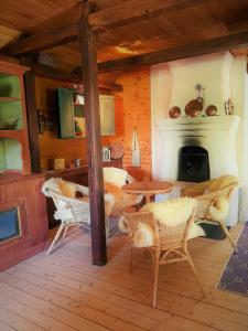 a living room with a fireplace and a table and chairs at Vargheden Bed & Breakfast in Malung