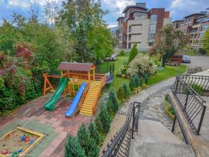 a playground with a slide and a slideintend at Apartamenty Bahus - Centrum in Ustroń