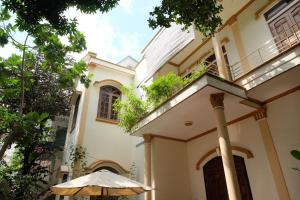 an umbrella in front of a house at Moon house tropical garden - East side in Nha Trang