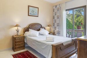 a bedroom with a large bed and a window at Villa Maria Portals Nous, by Priority in Portals Nous
