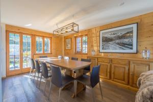 a dining room with a wooden table and chairs at Chalet Riquet - Ski/in-out - Jacuzzi in Nendaz