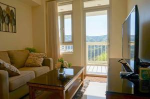a living room with a couch and a table at Tagaytay, Twinlakes, The Vineyard at Merlot in Balibaguhan