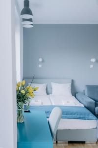 a bedroom with a bed and a blue table at APARTEL Plac Zbawiciela Studio in Warsaw