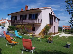 a group of chairs in the yard of a house at Comfortable and quiet apartment in Istria with privacy in Šajini