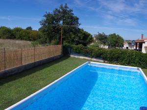 a swimming pool in the backyard of a house at Comfortable and quiet apartment in Istria with privacy in Šajini