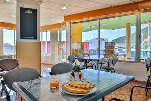 a table with a plate of bread and orange juice on it at Hotel Iberico in Castell de Ferro