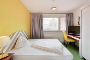 En eller flere senger på et rom på Am Neutor Hotel Salzburg Zentrum
