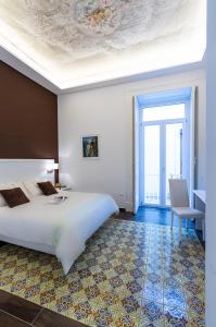Postel nebo postele na pokoji v ubytování Suites Sorrento Elegance