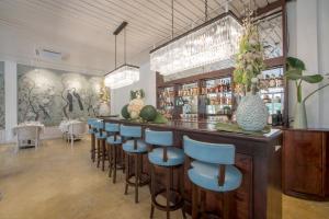 a bar with blue bar stools in a restaurant at The Apsara in Luang Prabang