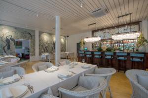 a dining room with tables and chairs and a bar at The Apsara in Luang Prabang