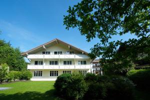 a white building with a red roof at Aktiv Hotel Schweiger in Füssen