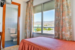 Säng eller sängar i ett rum på Hotel Iberico