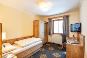 Łóżko lub łóżka w pokoju w obiekcie Aparthotel Weningeralm