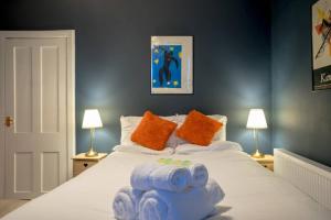 a bedroom with a bed with blue towels on it at ALTIDO Unique&Artsy Royal Mile Apt - Relive Music History in Edinburgh