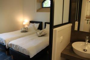 Letto o letti in una camera di Logies Tommenmolen