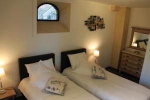 Letto o letti in una camera di Logies Tommenmolen