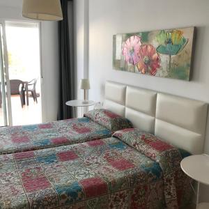 Postel nebo postele na pokoji v ubytování Hostal Tres Soles