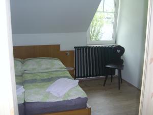 a small bedroom with a bed and a window at Das Haus am See in Grundlsee