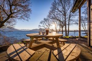 a picnic table with two chairs and a lake at The View in Isleornsay