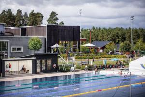 a swimming pool in front of a building at First Camp Lugnet-Falun in Falun