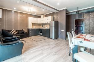 a kitchen and living room with a table and chairs at Borjomi cozy home in Borjomi