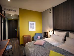 a bedroom with a bed and a desk and a chair at Panoramahotel Waldenburg in Waldenburg +29 photos