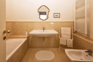 a bathroom with a sink and a tub and a mirror at La Residenza in Piazza Grande in Foligno +5 photos